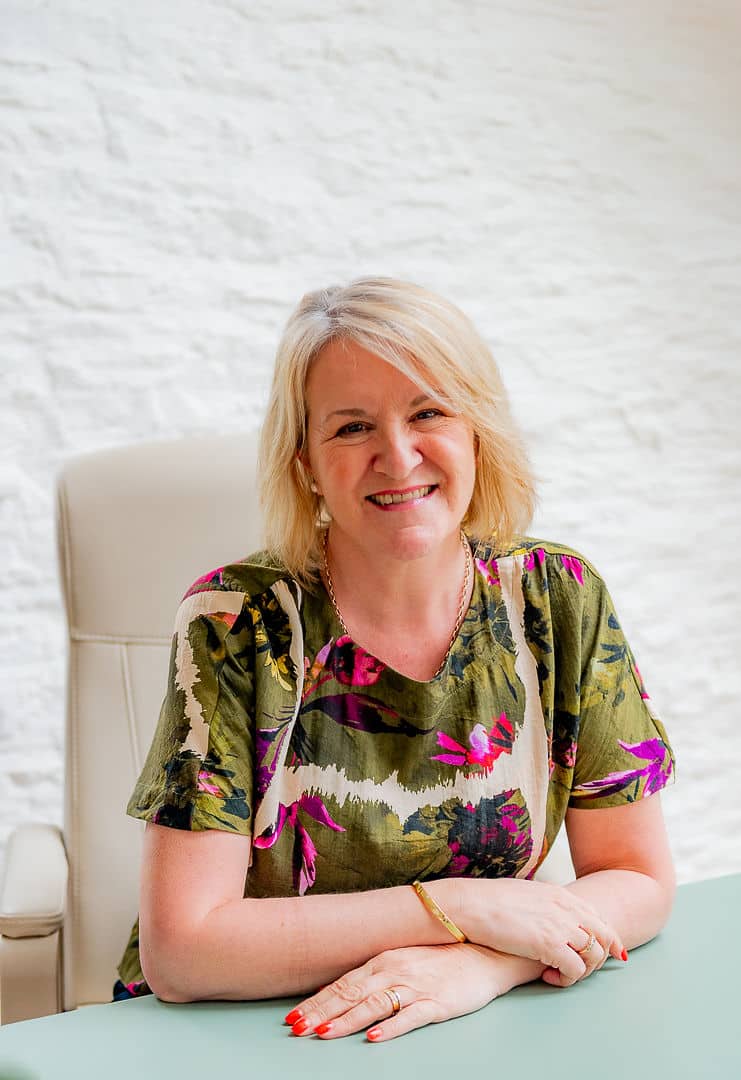 Photo of Louise Jenner, The Dream Job Coach sitting at a desk.
