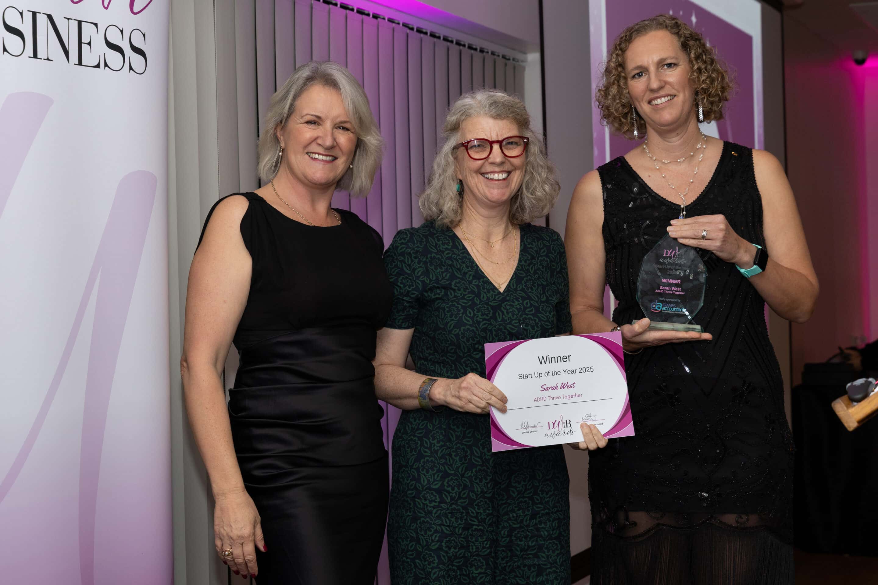 Louise Jenner, Sarah West and Lee McQueen pictured at the DWIB Awards 2025. Sarah is in the centre, holding her certificate as Lee presents her with her trophy for Start Up of the Year.