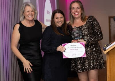 Louise Jenner and Emma Woodward present Katherine Harvey with her DWIB Award for Small Business of the Year 2025.