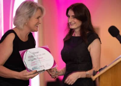 Louise Jenner, The Dream Job Coach, presents Hazel Anderson with her certificate and trophy for winning the DWIB Award, Employee of the Year 2025.