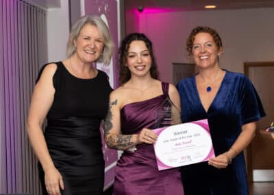 Louise Jenner and Natalie Hyson present Andie Durnell (centre) with her DWIB Award for Sole Trader of the Year 2025.