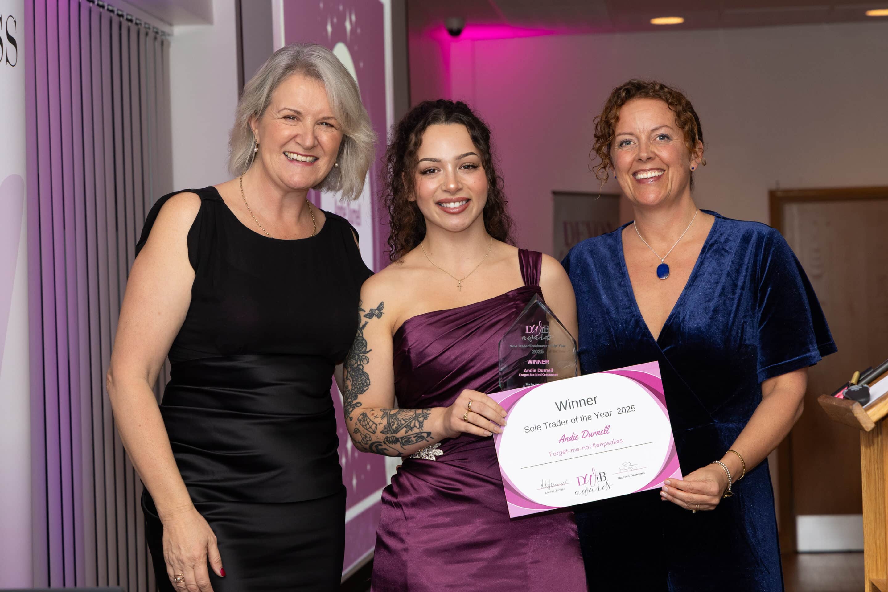 Louise Jenner and Natalie Hyson present Andie Durnell (centre) with her DWIB Award for Sole Trader of the Year 2025.