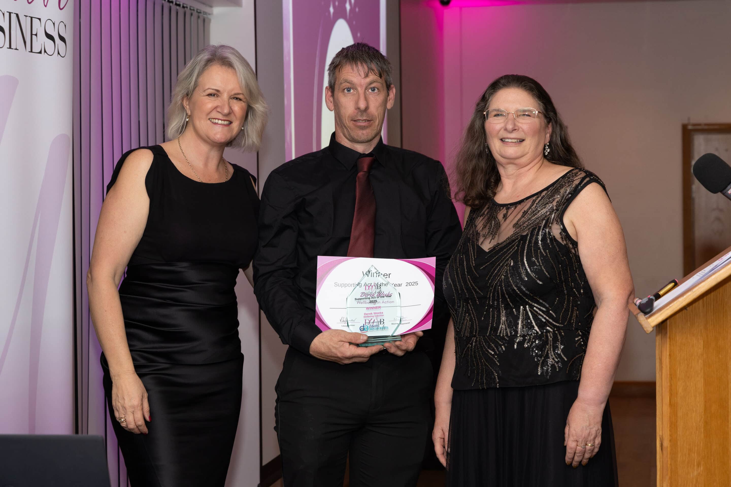 Louise Jenner and Maureen Townsend present Derek Weeks with his DWIB Award for winning the Best Supporting Act category 2025.