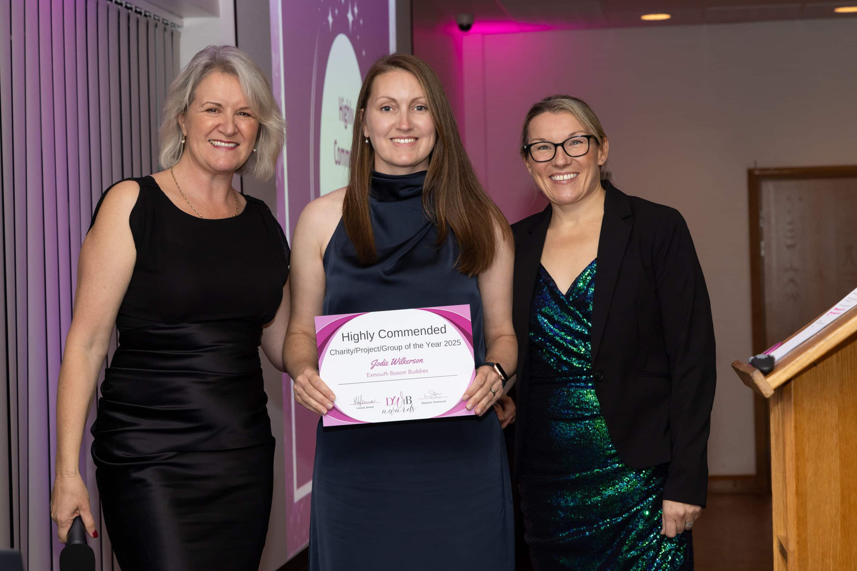 Davina Cull and Louise Jenner present Kate Smith (centre) with her DWIB Award for Charity of the Year 2025.