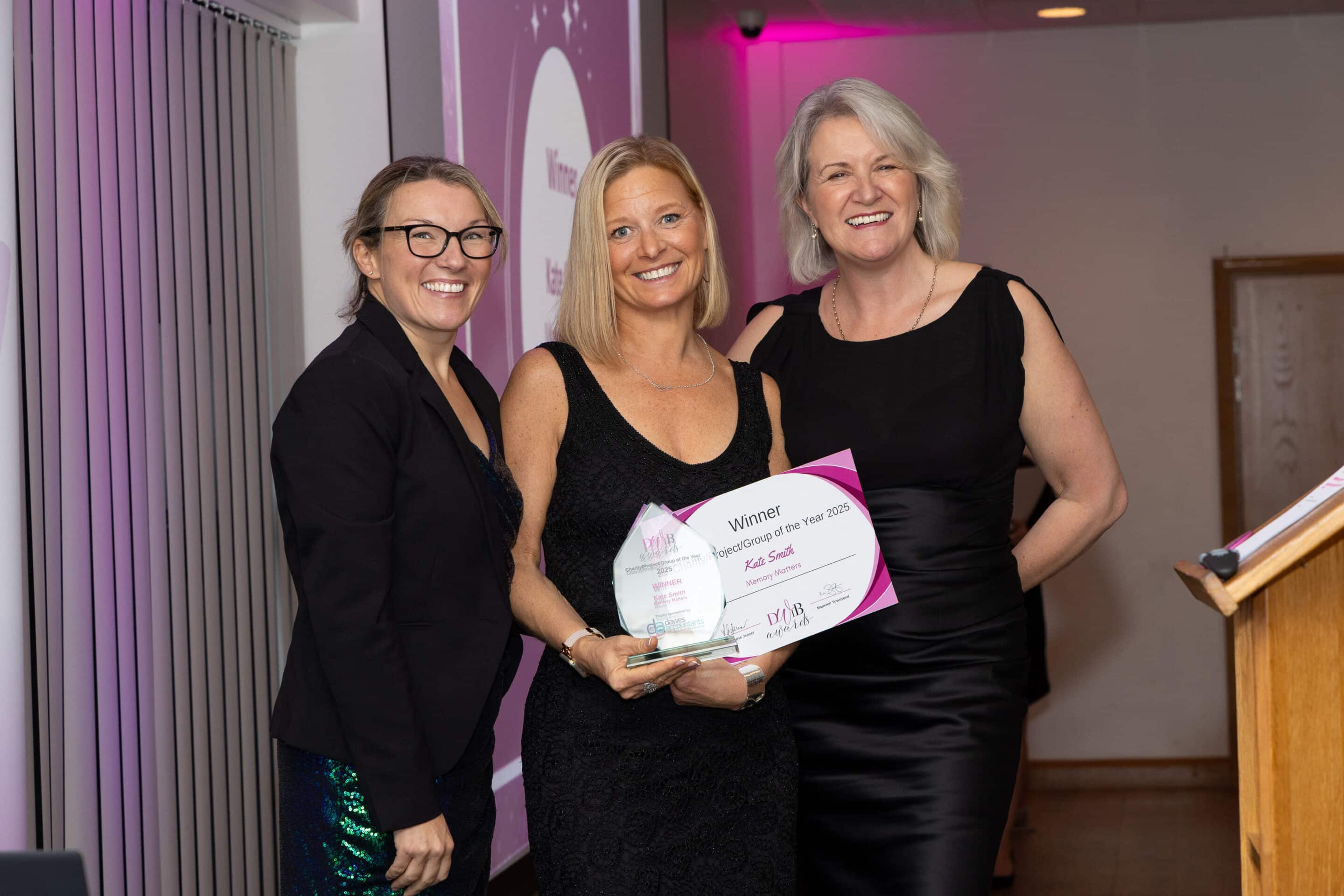 Davina Cull and Louise Jenner present Kate Smith (centre) with her DWIB Award for Charity of the Year 2025.