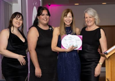 Mollie and Jess from Ladram Bay present Suzanne Vickerstaff with her trophy and certificate for winning the DWIB Award for Customer Service Excellence 2025. Louise Jenner is also pictured.