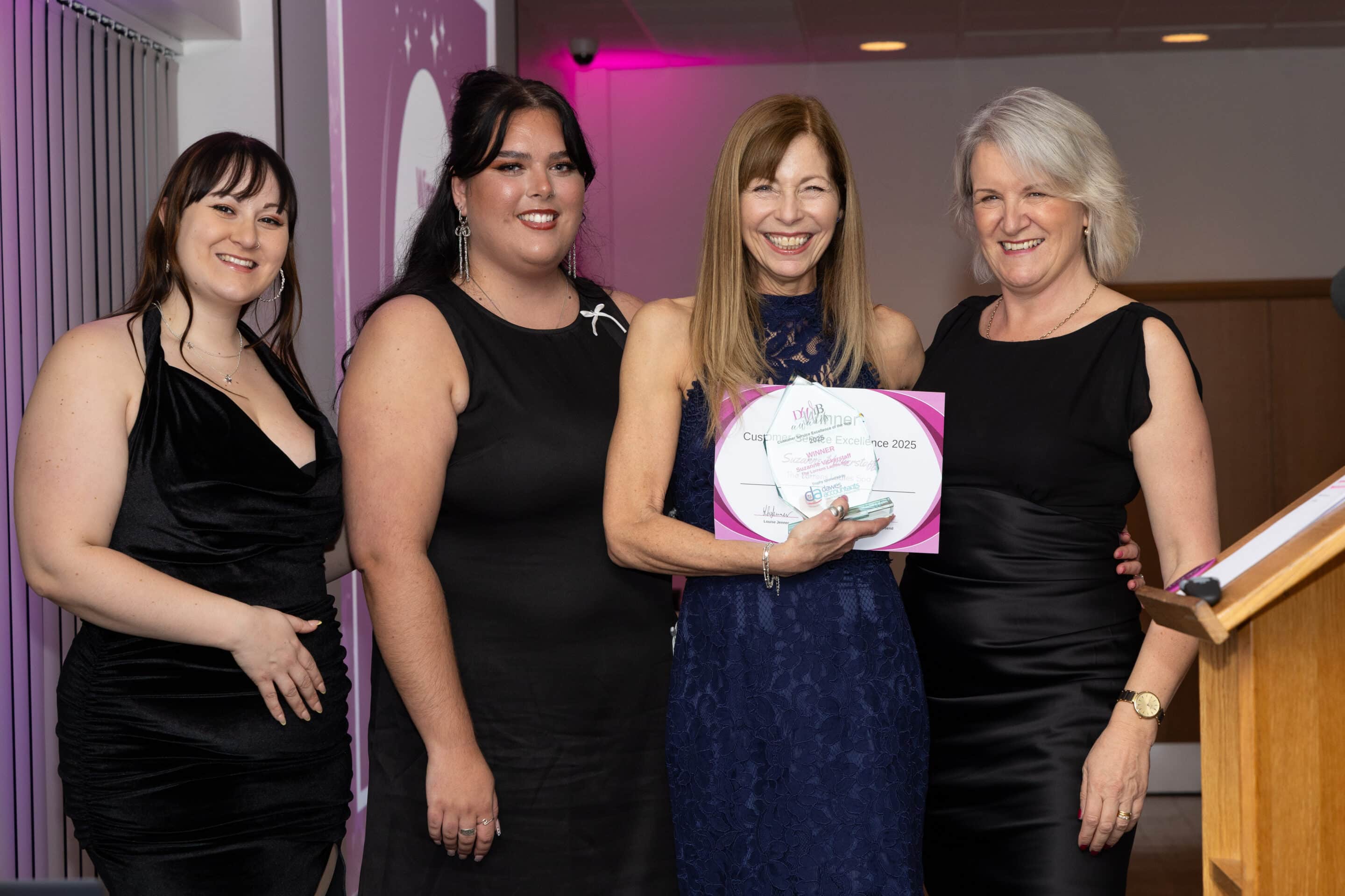 Mollie and Jess from Ladram Bay present Suzanne Vickerstaff with her trophy and certificate for winning the DWIB Award for Customer Service Excellence 2025. Louise Jenner is also pictured.