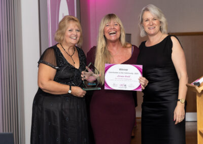 Jenny Paton (Newton Abbot Racecourse) and Louise Jenner present Lorraine Arnold with her DWIB Award for Contribution to the Community 2025.
