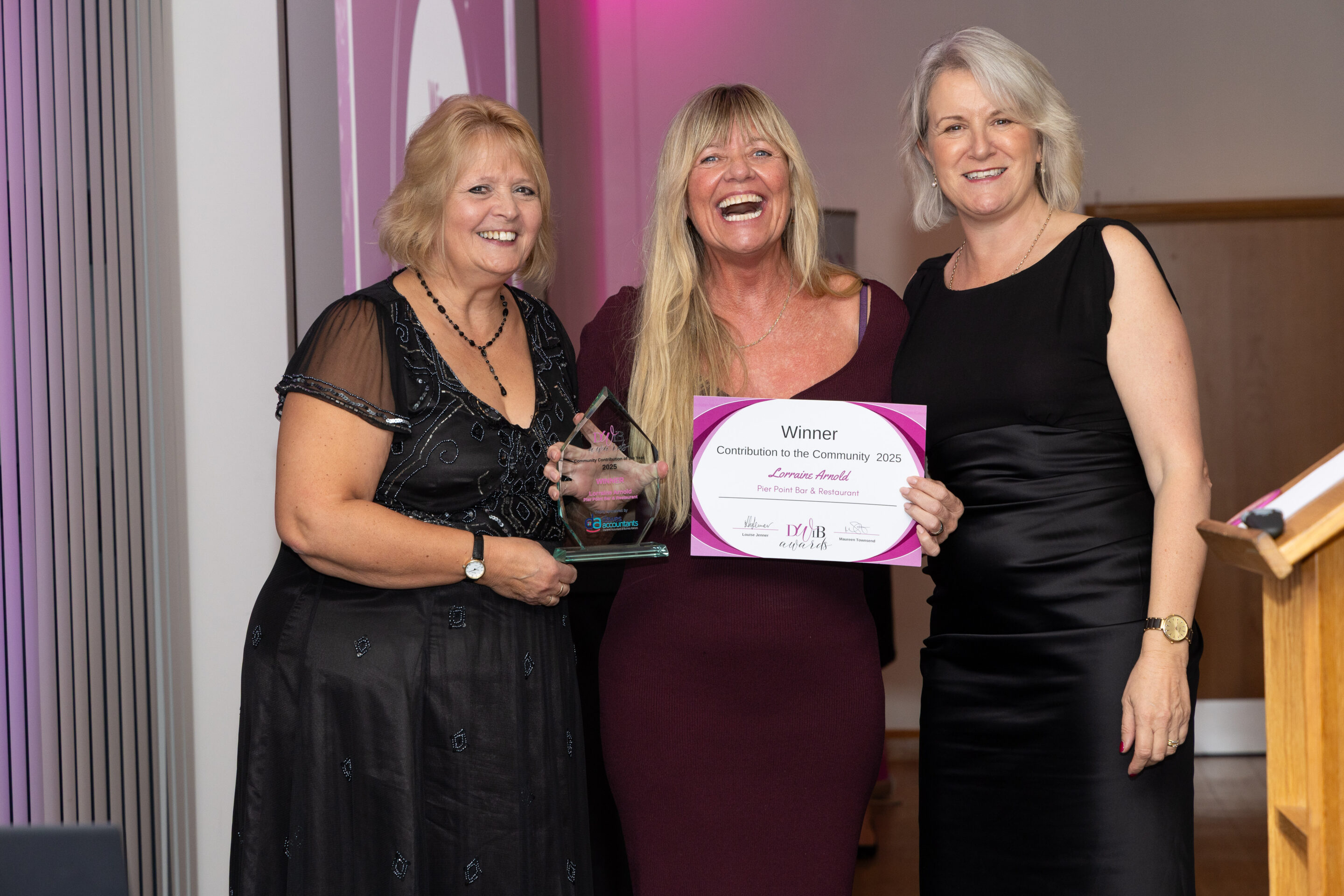 Jenny Paton (Newton Abbot Racecourse) and Louise Jenner present Lorraine Arnold with her DWIB Award for Contribution to the Community 2025.