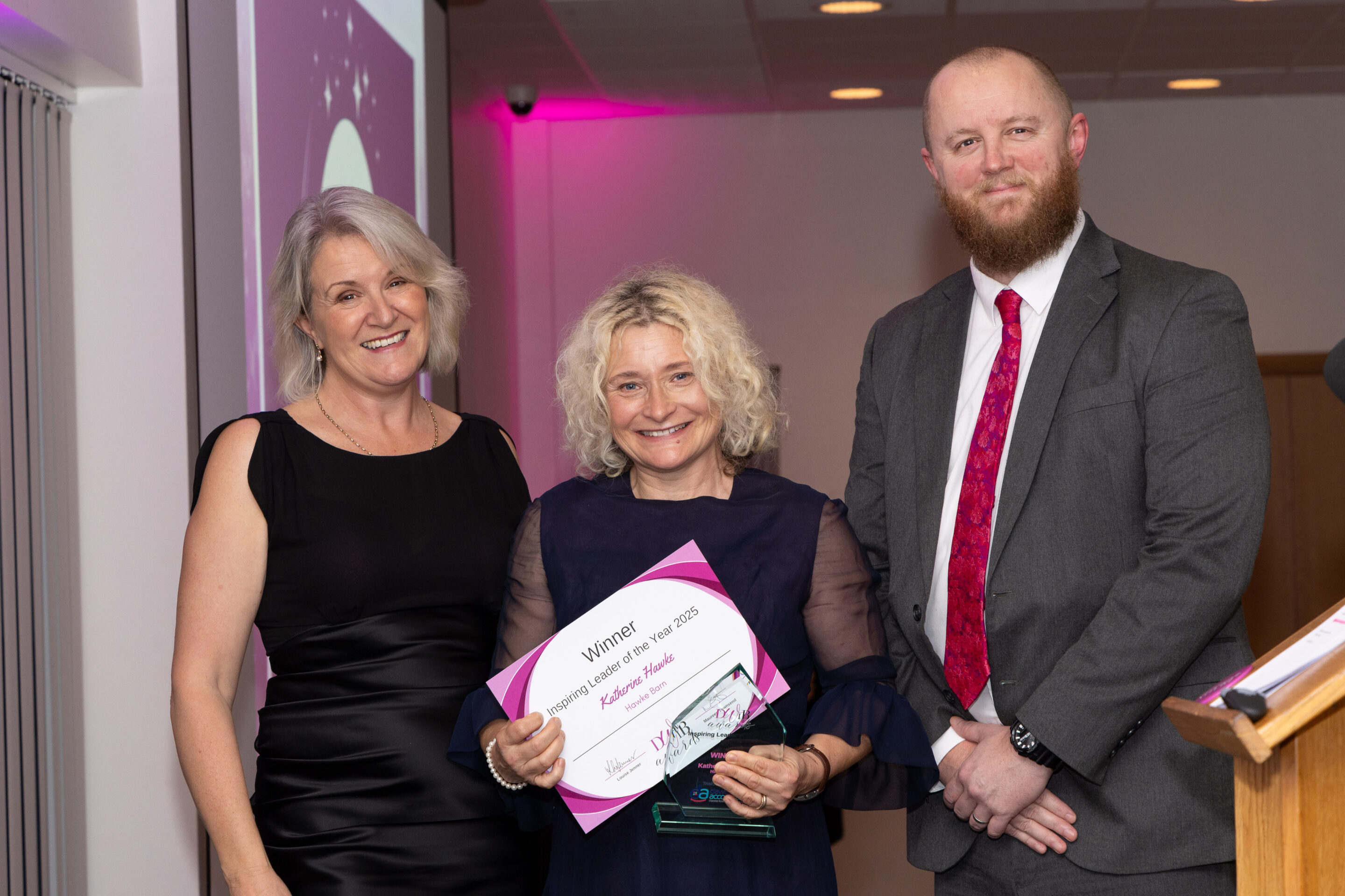 Louise Jenner and Gavni Harris present the DWIB Award 2025 for Inspirational Leader to Katherine Hawke (centre).