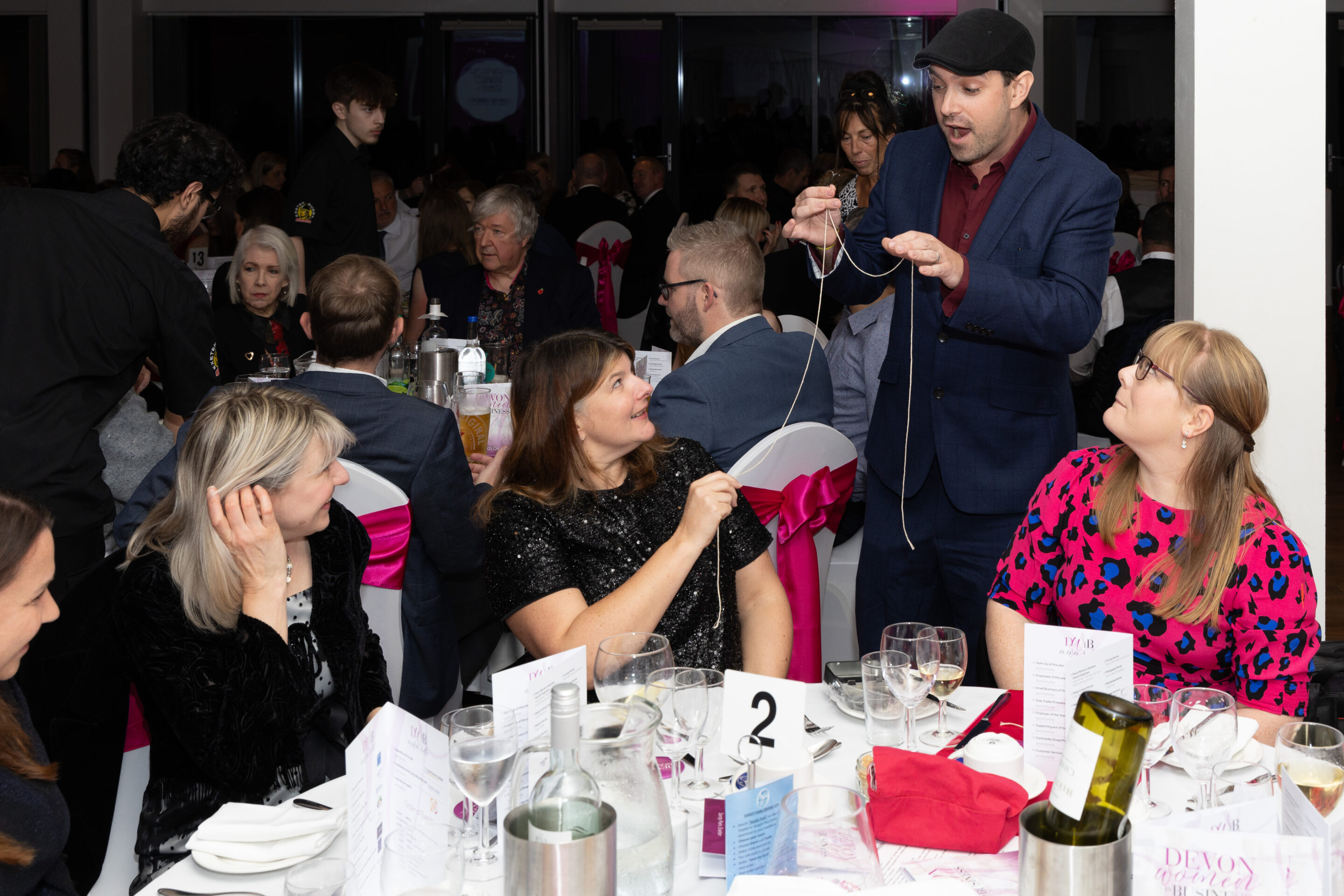 Richard John mesmerising guests at the DWIB Awards with his magic tricks.