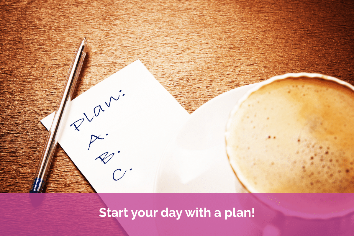 Notebook with a handwritten daily plan beside a pen and a cup of coffee on a wooden desk, illustrating the importance of starting the working day with clear priorities and focus.
