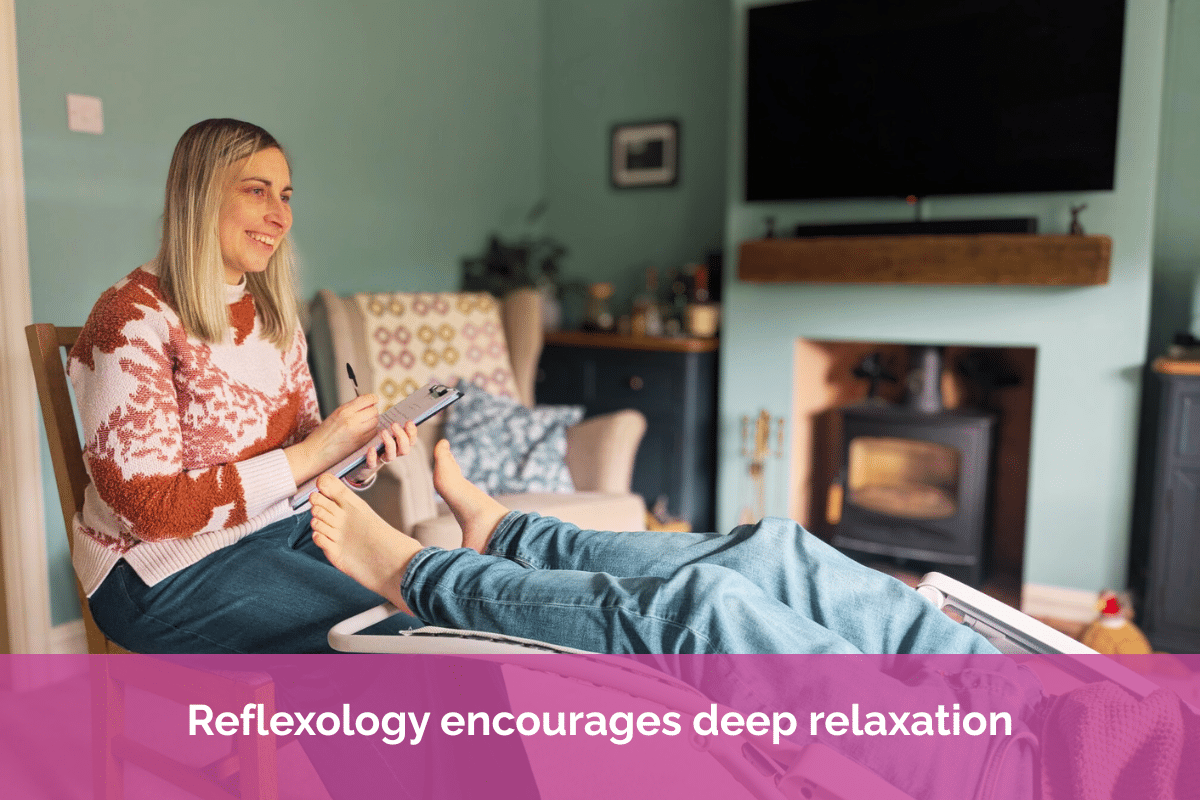 Reflexologist Hannah Heavens consulting with a client before a reflexology treatment in a warm and welcoming therapy room.
